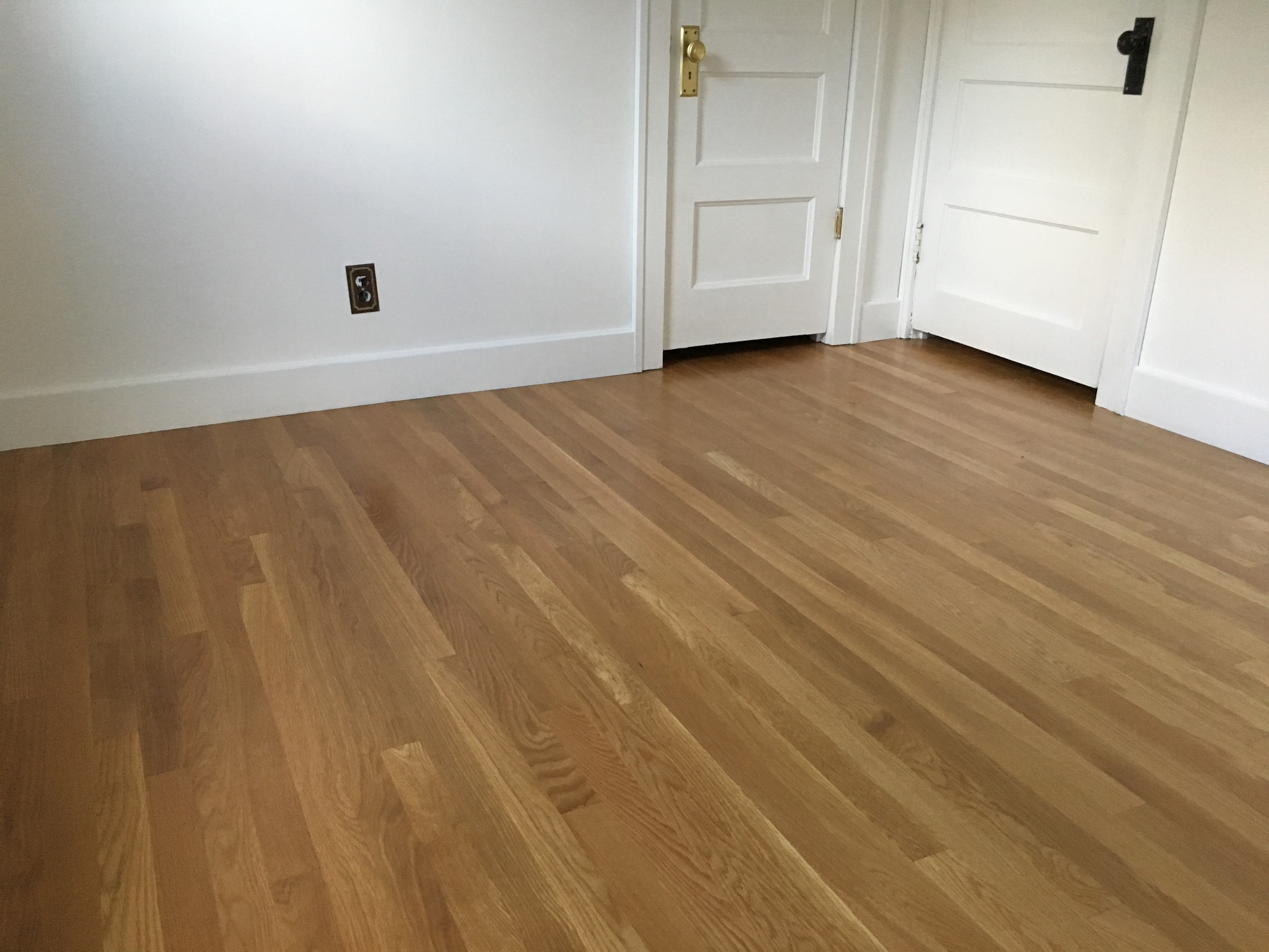 Installation and finishing of oak flooring.